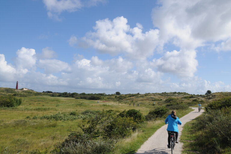 Woman cycling on bike on Schiermonnikoog island in the Netherlands