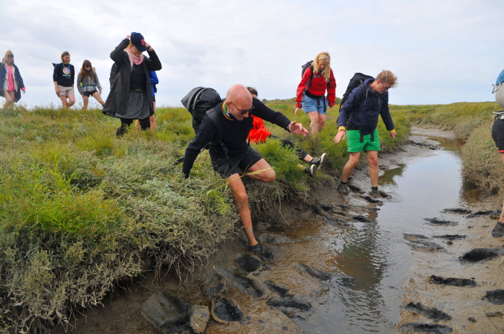 people walking in the mud on Schiermonnikoog